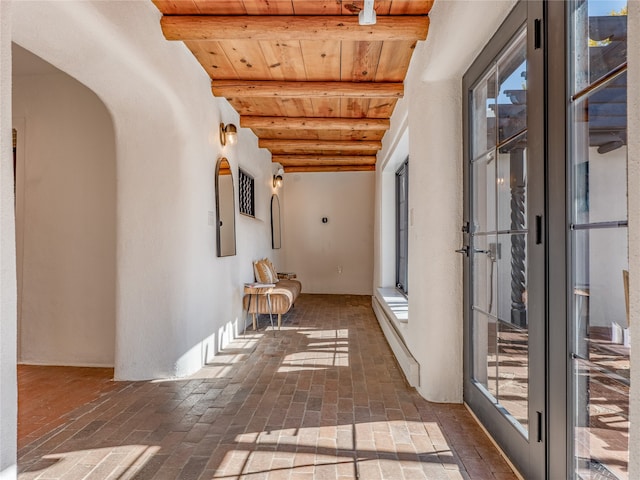 hall with beam ceiling and wooden ceiling