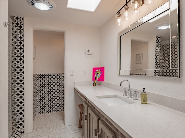 bathroom with tile flooring and large vanity