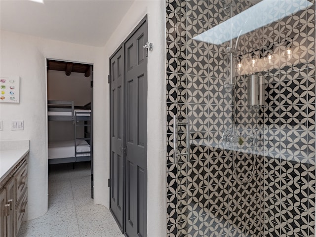 bathroom with tile floors and vanity