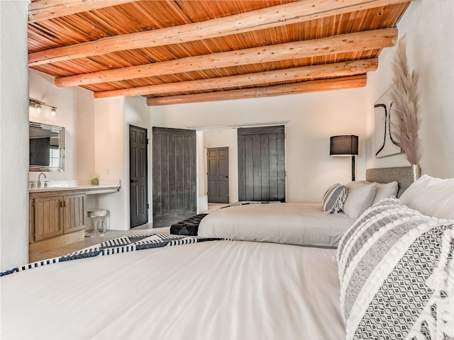 bedroom featuring wood ceiling, beam ceiling, and connected bathroom