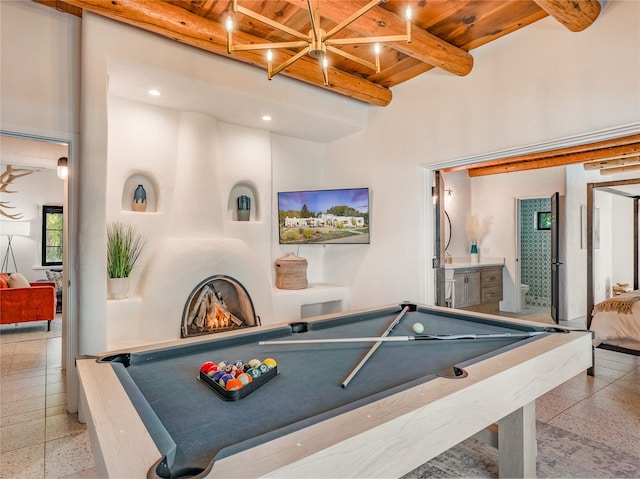 game room with beamed ceiling, pool table, and light tile floors