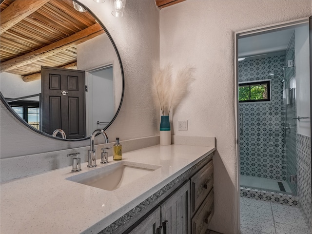 bathroom featuring walk in shower, tile floors, and large vanity