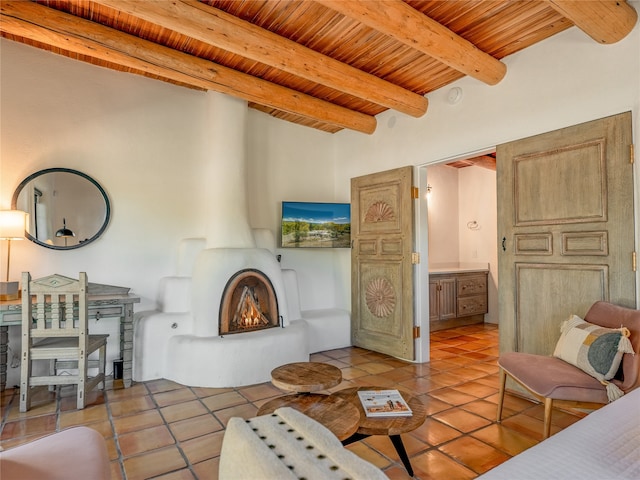 tiled living room featuring wood ceiling, a large fireplace, and beamed ceiling