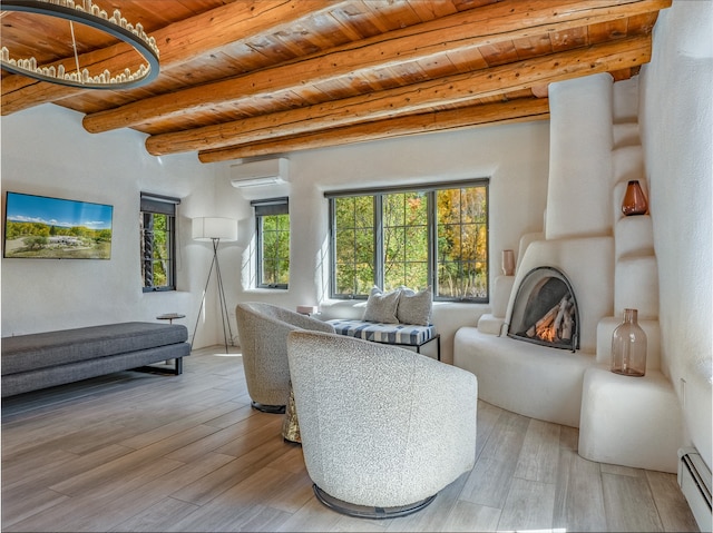 sitting room with beam ceiling, a baseboard heating unit, light hardwood / wood-style flooring, and wood ceiling