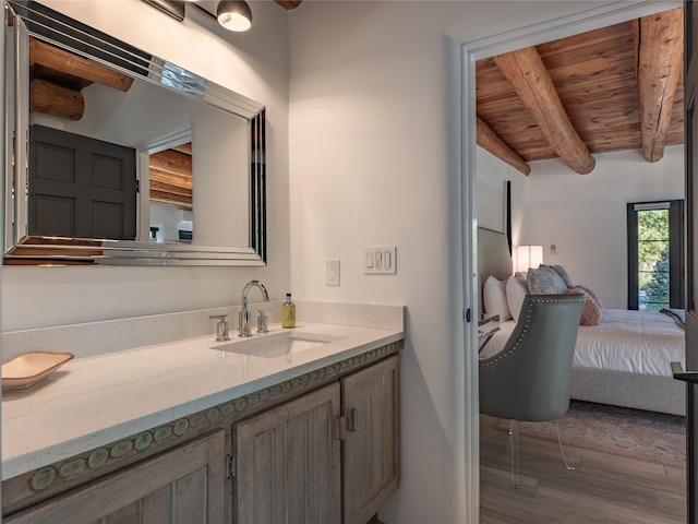 bathroom featuring oversized vanity, beam ceiling, wood ceiling, and hardwood / wood-style floors