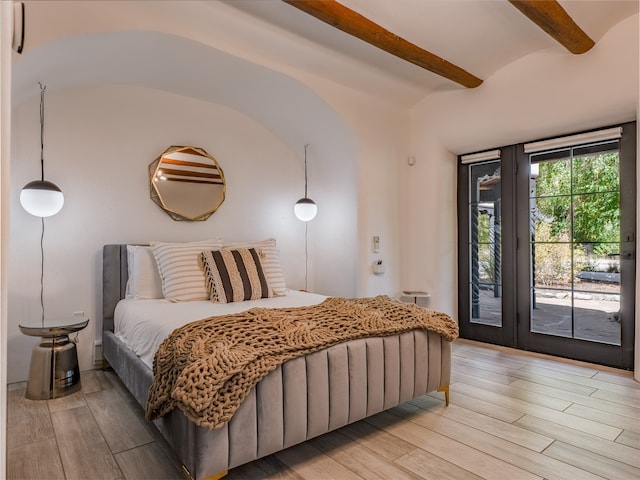 bedroom with beamed ceiling, access to outside, and light hardwood / wood-style flooring