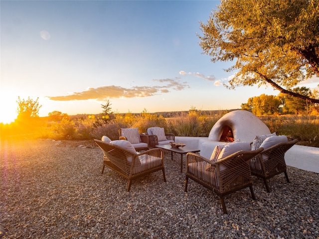 patio terrace at dusk featuring outdoor lounge area