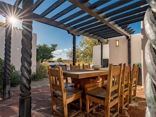 view of patio featuring an outdoor bar and a pergola