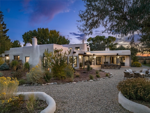 view of back house at dusk