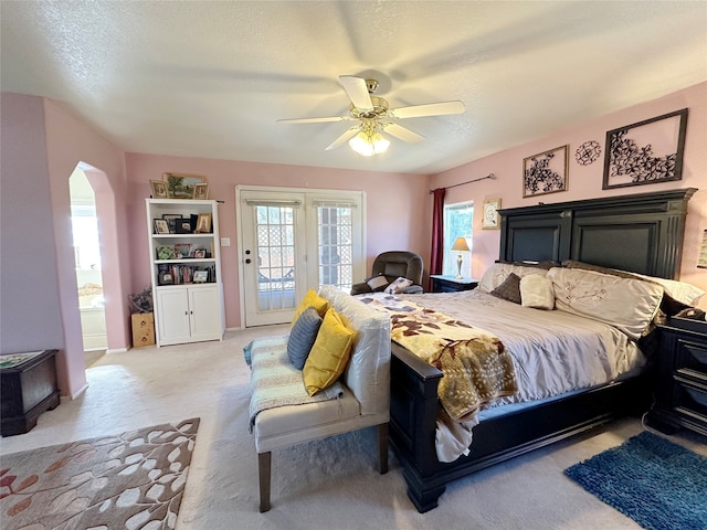 carpeted bedroom featuring ceiling fan, a textured ceiling, and access to exterior