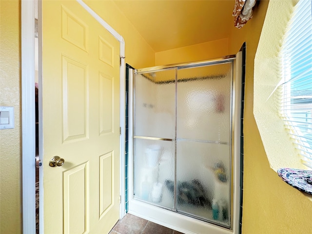 bathroom featuring an enclosed shower and tile patterned flooring