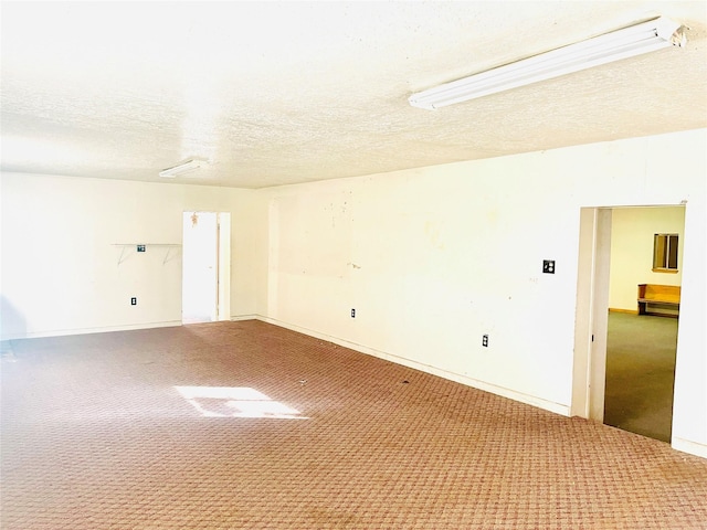 carpeted spare room featuring a textured ceiling