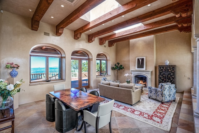 tiled living room with a water view and beamed ceiling