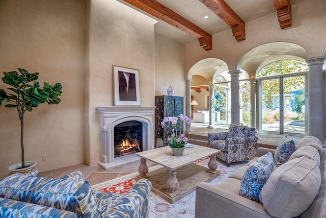 living room with decorative columns, light tile floors, and beamed ceiling