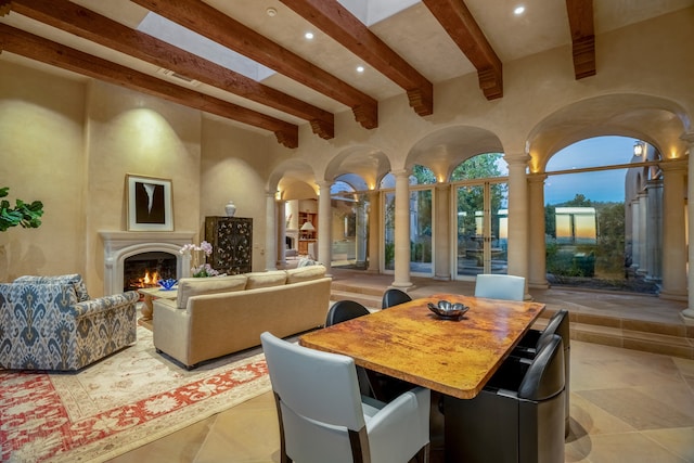 tiled dining space with beamed ceiling and ornate columns