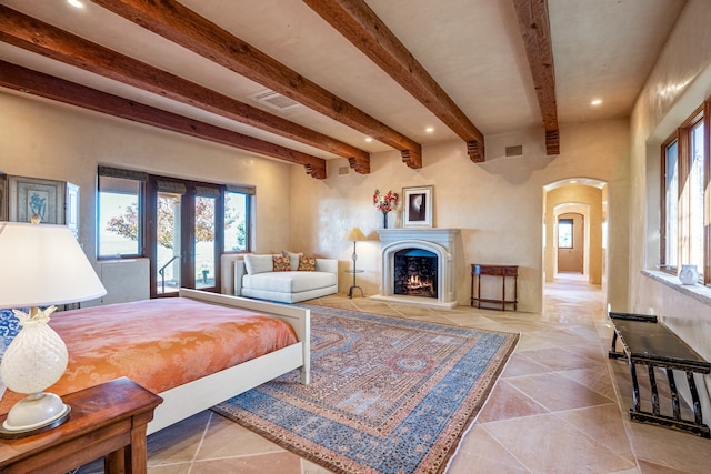 tiled bedroom featuring french doors and beam ceiling