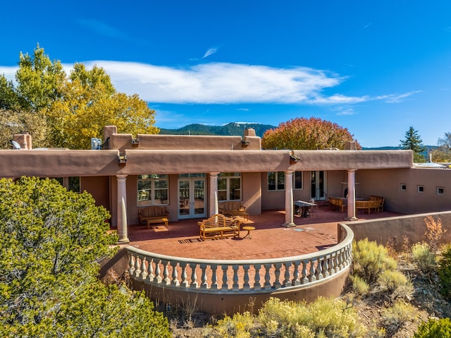 back of property with a patio and french doors