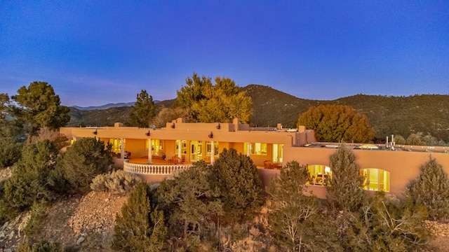 back house at dusk with a mountain view