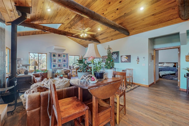 dining area with beamed ceiling, ceiling fan, wood ceiling, hardwood / wood-style floors, and a wood stove