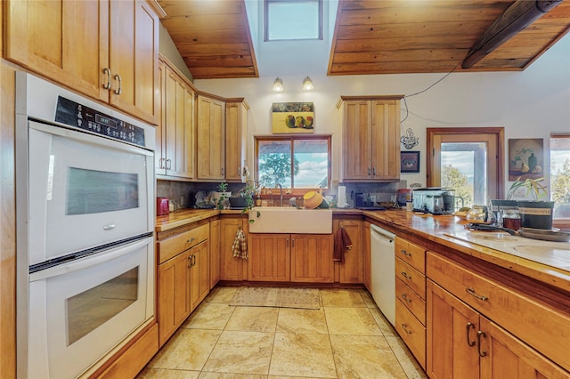 kitchen featuring sink, light tile floors, and wooden ceiling