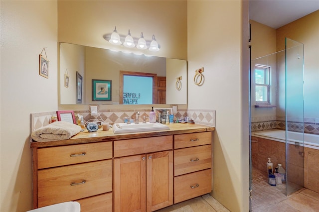 bathroom with backsplash, a shower with door, vanity, and tile flooring