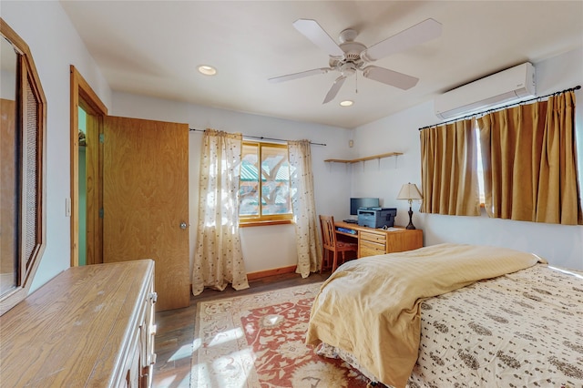 bedroom featuring a closet, ceiling fan, hardwood / wood-style flooring, and a wall unit AC