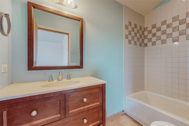 bathroom with vanity, tiled shower / bath, and tile flooring