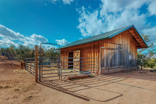 view of horse barn featuring an outdoor structure