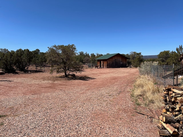 view of yard with a rural view and an outdoor structure