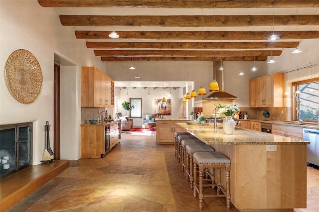 kitchen featuring light brown cabinetry, decorative backsplash, and exhaust hood