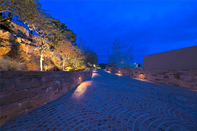 view of pool at twilight