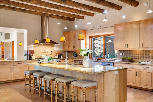 kitchen featuring light tile patterned flooring, wall chimney range hood, decorative backsplash, light brown cabinets, and light stone counters