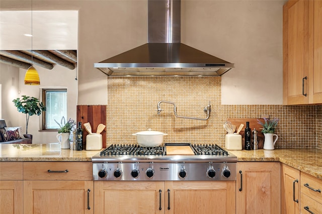 kitchen with stainless steel gas cooktop, decorative backsplash, light brown cabinets, and wall chimney exhaust hood