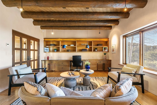 living room with beam ceiling, light hardwood / wood-style flooring, and french doors