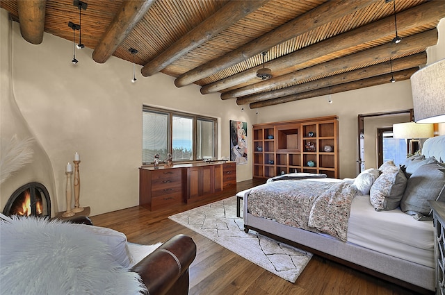 bedroom with beam ceiling, dark hardwood / wood-style floors, and wood ceiling