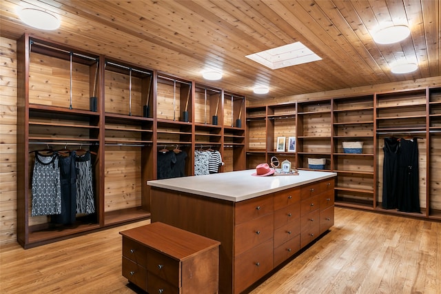 walk in closet featuring a skylight and light hardwood / wood-style flooring