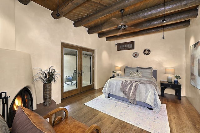 bedroom with beamed ceiling, wood ceiling, french doors, access to outside, and dark wood-type flooring