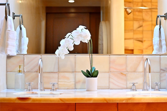 bathroom with dual vanity and decorative backsplash