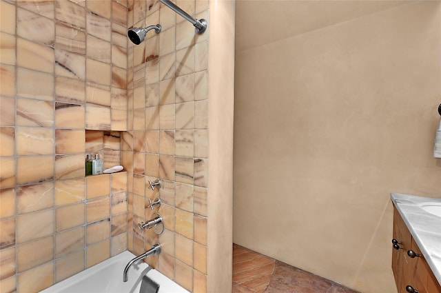 bathroom with vanity and tiled shower / bath