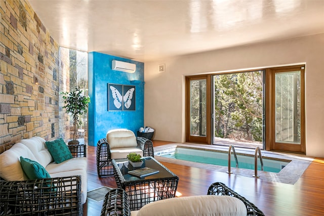 living room with hardwood / wood-style flooring and a wall mounted AC