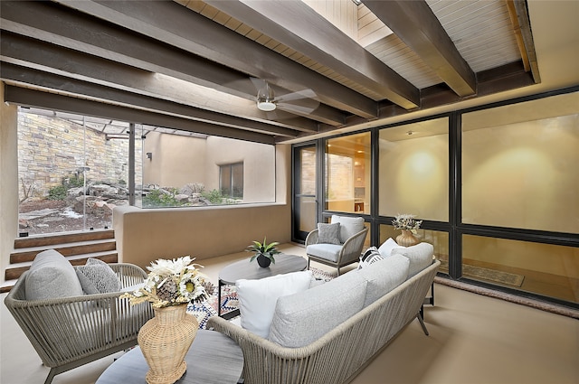 interior space with beamed ceiling and ceiling fan