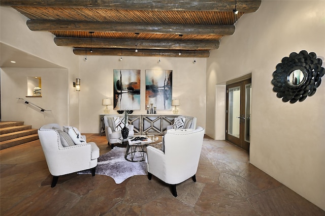 living room featuring beamed ceiling, french doors, and tile patterned floors