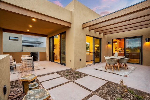 patio terrace at dusk with an outdoor hangout area and wine cooler