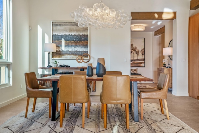 dining room featuring an inviting chandelier and light hardwood / wood-style flooring