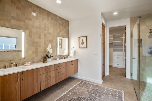 bathroom with tile walls, walk in shower, tile patterned floors, and vanity