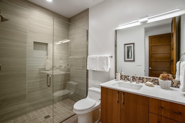 bathroom with vanity, an enclosed shower, decorative backsplash, and toilet