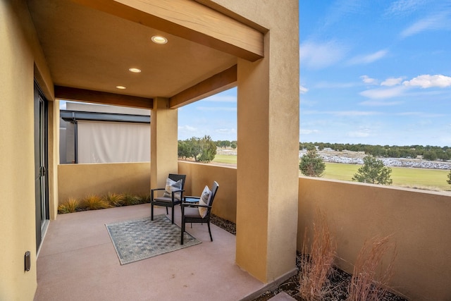 view of patio featuring a balcony