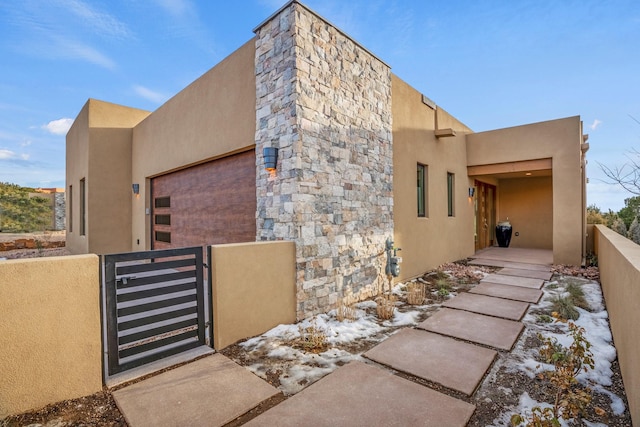 view of snow covered exterior with a garage