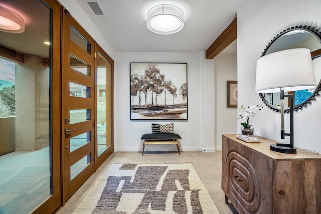 hall featuring french doors and beamed ceiling