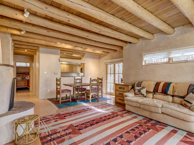 living room with rustic walls, beam ceiling, wooden ceiling, and light tile flooring